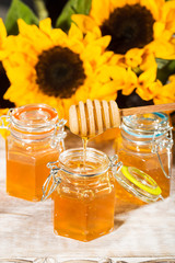 Fresh honey with colorful yellow sunflowers