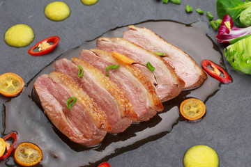 Pekin duck with vegetables over black background