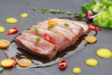 Pekin duck with vegetables over black background