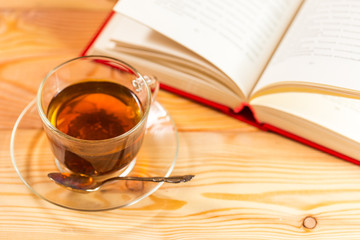 Cup of tea and books onwooden background 