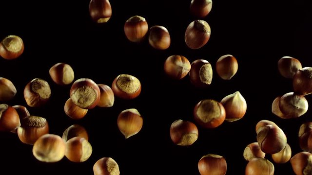 Nuts are flying on a black background