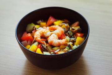 Closeup image of healthy vegetarian salad with shrimps, calamari