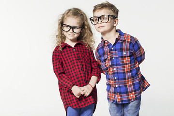 Funny lovely children.  fashionable little boy and girl in glasses, jeans, white t-shirts and plaid shirts.stylish kids in casual shoes. fashion children