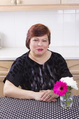 Happy mature woman smiling in kitchen