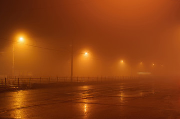 Street lights in foggy misty night,
