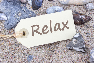Relax / Card on the sandy beach with text: Relax