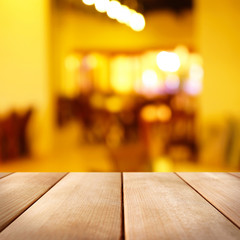 Empty wooden table and blurred interior background