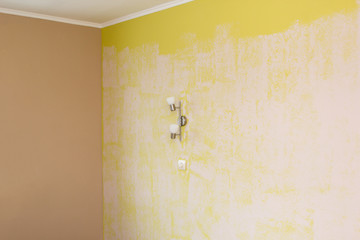 yellow wall painted with a textured paint roller