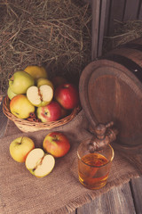 Composition of fresh apples and tasty cider on wooden table
