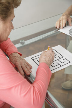 Elderly Woman Trying Brain Teasers