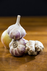 Onion Garlic and Ginger on Dark Background