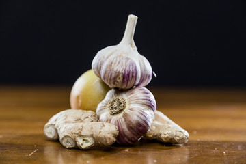 Onion Garlic and Ginger on Dark Background