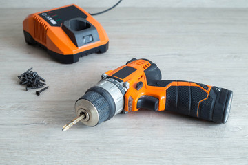 Electric screwdriver on wooden background