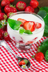 Glass with strawbery dessert with fresh berry. Vertical image.