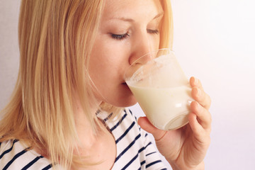 Woman drinking milk / yogurt . Dairy products concept