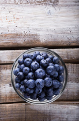 Berries in a glass jar on old rustic wooden table