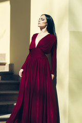 Naklejka premium Woman in red dress outdoor
