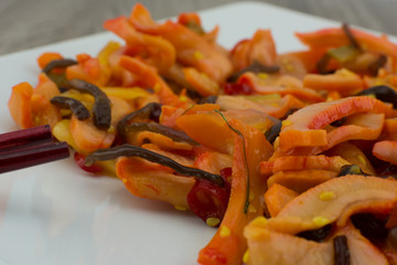 Squid Salad / Calamari Salad (Chuka Ika Sansai). Asian salad of squid with vegetables on a white plate