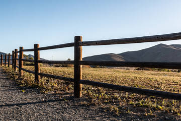 Fence line and mountain peak in distance at Mountain Hawk Park in Chula Vista, California. 