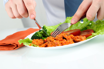 Young business  man eating a healthy salad with meat