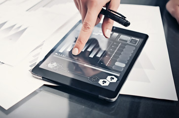 Closeup photo woman working market reports modern tablet and touching screen with worldwide stock...