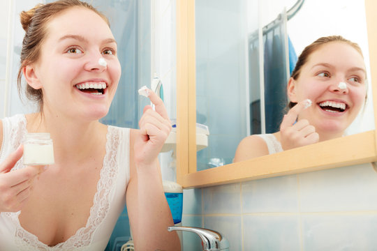 Woman applying moisturizing skin cream. Skincare.