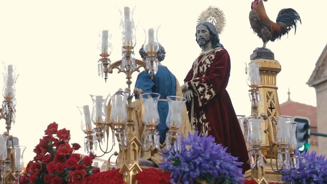 People carry the statue of Jesus Christ decorated with fresh flowers during Holy Week Processions.