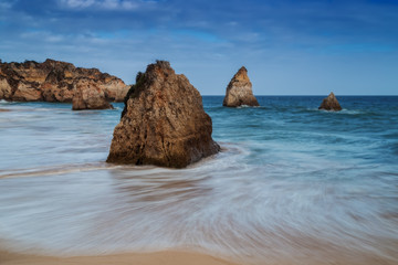 Waves crashing against the rocks. 