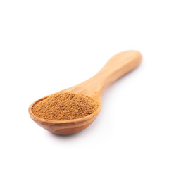 Wooden spoon full of cinnamon