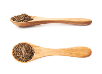 Wooden spoon full of cumin seeds