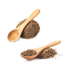 Wooden spoon over the pile of cumin