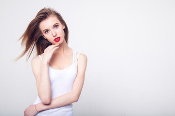 Sensual young woman with beautiful long brown hairs, posing isolated on white