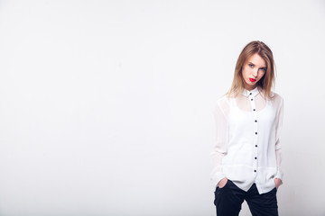 Portrait of a fashionable young brunette beauty in white shirt.