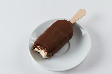 Chocolate covered vanilla and raspberry popsicle
