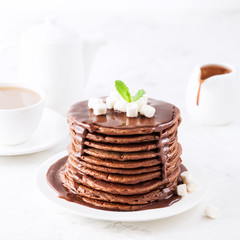 Chocolate pancakes with marshmallows at breakfast