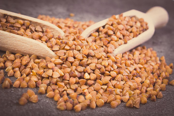 Vintage photo, Buckwheat groats with spoon on cement structure