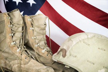Old combat boots and helmet with American flag
