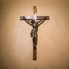 Crucifix on wall in spotlight. Jesus Christ on cross. Religion, belief and hope. Holy and sacred...