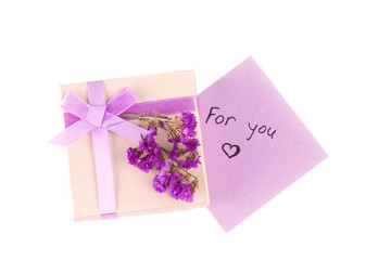 Gift box with purple ribbon bow, isolated on white