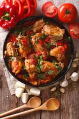 chicken stew with vegetables on a table close-up. vertical top view 
