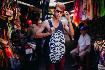 asian artist man with guitar  at local market in Nha Trang