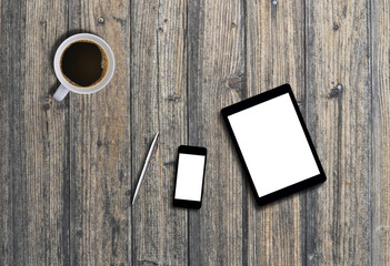 Office desk top view with tablet, smartphone, pen and coffee for mock up. Wooden background