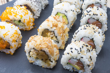 Sushi rolls on a slate plate