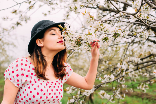 female in vintage clothes in cherry blossom