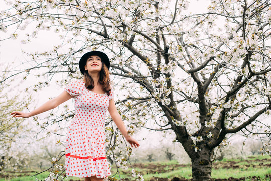 female in vintage clothes in cherry blossom