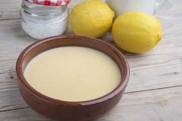 Traditional creme brulee on ceramic dish on wooden table