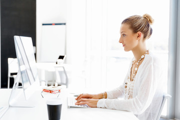 Attractive office worker sitting at desk