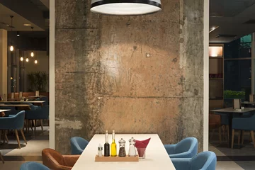 Schilderijen op glas Modern restaurant interior with concrete wall © interiorphoto