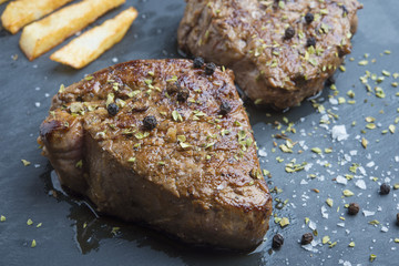 cooked beef chateaubriand steak with chunk chipped potatoes on p