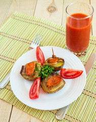 Homemade potatoes baked on a thin stick with bacon and herbs on a wooden background. 